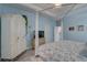 Spacious main bedroom featuring a tray ceiling, wooden floors, and white furniture at 5104 2Nd E Ave, Palmetto, FL 34221