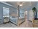 Spacious main bedroom featuring a tray ceiling, wooden floors, and white furniture at 5104 2Nd E Ave, Palmetto, FL 34221