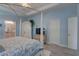 Spacious main bedroom featuring a tray ceiling, wooden floors, and white furniture at 5104 2Nd E Ave, Palmetto, FL 34221