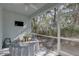 This is a screened patio with a ceiling fan and a table with chairs at 5104 2Nd E Ave, Palmetto, FL 34221