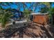Quaint backyard with a paver patio, shed, lush plants, and a tiki torch at 525 Lexington St, Dunedin, FL 34698