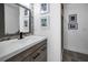 Modern bathroom with unique hexagon backsplash and sleek black hardware on vanity at 525 Lexington St, Dunedin, FL 34698