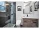 Modern bathroom featuring glass shower, wood vanity, and stylish fixtures at 525 Lexington St, Dunedin, FL 34698