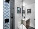 Sleek bathroom featuring glass shower with decorative tile, modern fixtures, and stylish vanity at 525 Lexington St, Dunedin, FL 34698