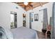 Bright bedroom featuring a vaulted ceiling, wood floors, and an attached bathroom at 525 Lexington St, Dunedin, FL 34698