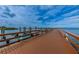 Scenic dock with boats, offering waterfront access and views of the calm sea under a partly cloudy sky at 525 Lexington St, Dunedin, FL 34698