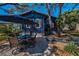 Charming blue home with a spacious patio and outdoor dining area at 525 Lexington St, Dunedin, FL 34698