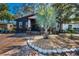Charming home with a brick driveway, well-manicured landscaping, and a unique palm tree in the front yard at 525 Lexington St, Dunedin, FL 34698
