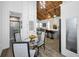 Bright kitchen with view to living room, featuring white cabinetry, stainless appliances, and modern dining set at 525 Lexington St, Dunedin, FL 34698