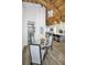Kitchen and dining area with a wood beam ceiling, modern light fixture, and a round table at 525 Lexington St, Dunedin, FL 34698