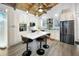Bright, open kitchen with white cabinets, island with seating, stainless steel appliances, and striking wood-beamed ceiling at 525 Lexington St, Dunedin, FL 34698