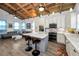 Open-concept kitchen and living space with granite island and stainless steel appliances at 525 Lexington St, Dunedin, FL 34698