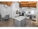 Open floor plan combines kitchen, dining, and living spaces with hardwood floors and vaulted ceilings at 525 Lexington St, Dunedin, FL 34698