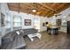 Open-concept living room and kitchen with island and wood beam ceiling at 525 Lexington St, Dunedin, FL 34698