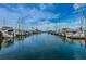Wide view of a marina filled with various boats and yachts reflecting on the calm water under a sunny sky at 525 Lexington St, Dunedin, FL 34698