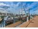 Picturesque marina view featuring various boats docked along a wooden pier with clear skies above at 525 Lexington St, Dunedin, FL 34698