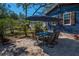 Inviting patio with an outdoor dining set and manicured landscaping at 525 Lexington St, Dunedin, FL 34698