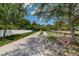 Pinellas Trail with a shady path, a bench, and a fence on a sunny day at 525 Lexington St, Dunedin, FL 34698