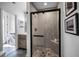 Modern shower with glass door and gray tiled walls with black trim at 525 Lexington St, Dunedin, FL 34698