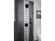 Modern shower with gray tile, decorative center, and matte black fixtures at 525 Lexington St, Dunedin, FL 34698
