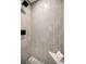 Bright, modern shower with gray tile, built-in seat, and a sleek shower head at 525 Lexington St, Dunedin, FL 34698