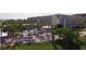 Aerial view of a resort featuring a large pool, palm trees, and a modern hotel building at 5500 Gulf Blvd # 4246, St Pete Beach, FL 33706
