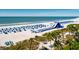 Panoramic view of the beach with a large inflatable water slide and tents for shade at 5500 Gulf Blvd # 4246, St Pete Beach, FL 33706