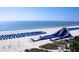 Beautiful beach scene with an inflatable water slide and organized rows of blue beach umbrellas at 5500 Gulf Blvd # 4246, St Pete Beach, FL 33706