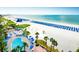 Aerial view of an oceanfront resort featuring a pristine beach and sparkling pool at 5500 Gulf Blvd # 4246, St Pete Beach, FL 33706
