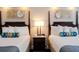 Comfortable bedroom featuring two beds, stylish decor, and a relaxing ambiance at 5500 Gulf Blvd # 4246, St Pete Beach, FL 33706