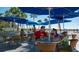 Gathering enjoying an outdoor meal with a view of the sandy beach and ocean at 5500 Gulf Blvd # 4246, St Pete Beach, FL 33706