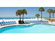 Beautiful pool with lounge chairs overlooking white sand beach and ocean at 5500 Gulf Blvd # 4246, St Pete Beach, FL 33706