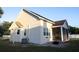 Back exterior showcasing the home's structure, including a screened-in porch and tidy landscaping, great for relaxing in comfort at 601 Gay Rd, Seffner, FL 33584
