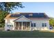 Spacious backyard featuring solar panels on the roof and a screened-in patio with seating at 601 Gay Rd, Seffner, FL 33584
