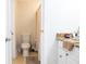 Bathroom features a toilet, tile floors, and vanity with granite countertop at 601 Gay Rd, Seffner, FL 33584