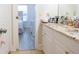 Bathroom vanity with granite countertop, a sink, and a bedroom visible through the open doorway at 601 Gay Rd, Seffner, FL 33584