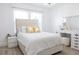 Bright bedroom featuring a tufted headboard bed, vanity, and windows with natural light at 601 Gay Rd, Seffner, FL 33584