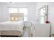 Bedroom featuring a vanity area, large window, and a luxuriously padded headboard at 601 Gay Rd, Seffner, FL 33584