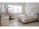 Bright bedroom features tile floors, a hanging chair and a tray on the bed at 601 Gay Rd, Seffner, FL 33584