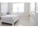 Serene bedroom with white tile flooring, a queen bed, and natural light at 601 Gay Rd, Seffner, FL 33584