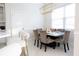 Dining room with large window, modern light fixture, and seating for six at 601 Gay Rd, Seffner, FL 33584