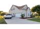Exterior view of a two-story home, a driveway, a white garage door, and a car at 601 Gay Rd, Seffner, FL 33584
