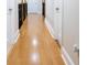 Upstairs hallway featuring bamboo floors, white trim, and wood railing at 601 Gay Rd, Seffner, FL 33584