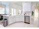 Bright kitchen featuring white cabinetry, a stainless steel dishwasher, and granite countertops at 601 Gay Rd, Seffner, FL 33584