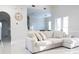 Bright, neutral living room features tile floors and views into the kitchen and dining area at 601 Gay Rd, Seffner, FL 33584