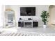 Living room with TV, modern media console, and decorative gold mirror at 601 Gay Rd, Seffner, FL 33584