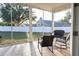 Screened-in porch featuring tiled flooring, outdoor seating, and views of the backyard at 601 Gay Rd, Seffner, FL 33584