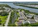 Stunning aerial view of a waterfront townhome community with lush greenery and scenic water views of the bay at 618 Wheaton Trent Pl, Tampa, FL 33619