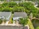 An aerial view of a well-maintained townhome community with lush landscaping, a serene pond, and convenient street access at 618 Wheaton Trent Pl, Tampa, FL 33619