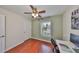 Bright bedroom with hardwood floors, ceiling fan, and view of outside at 618 Wheaton Trent Pl, Tampa, FL 33619